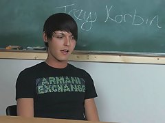 Lovely young twink pornstar Trey Korbin is sitting at a desk wearing a t-shirt and looking totally hot twink gay nude at Teach Twinks